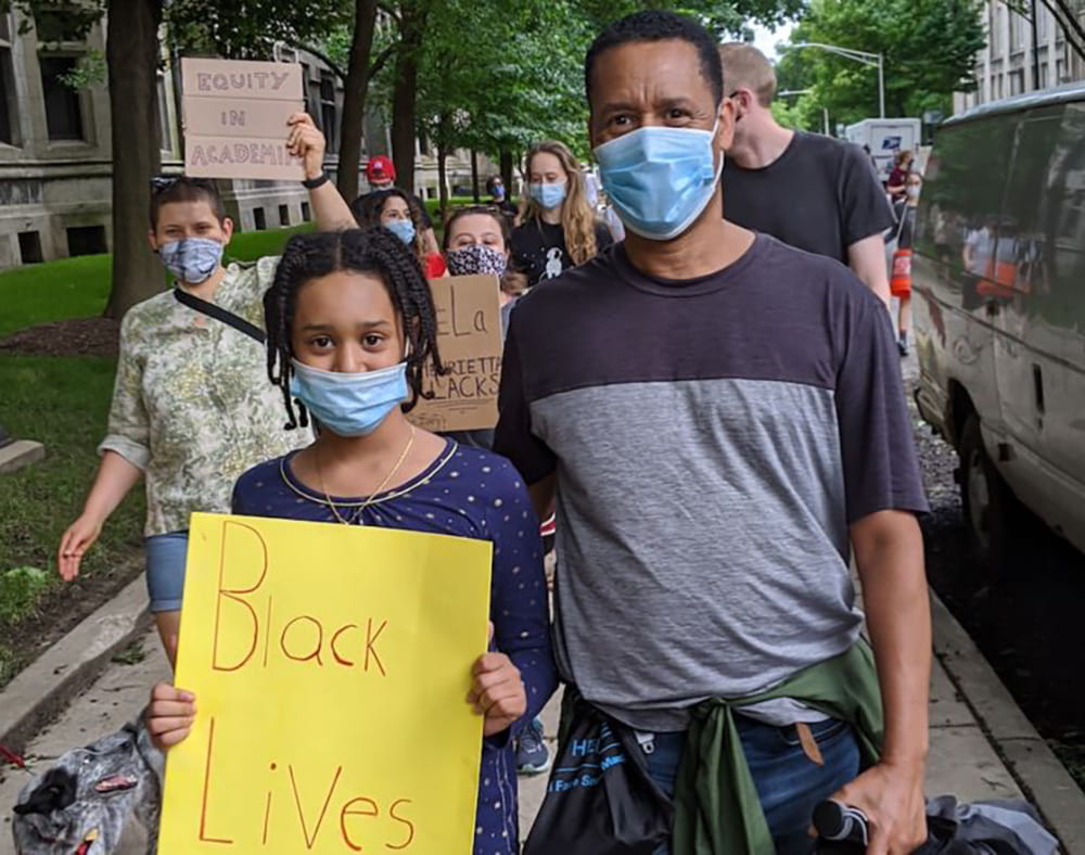 Zeray with his daughter at a Black Lives Matter protest